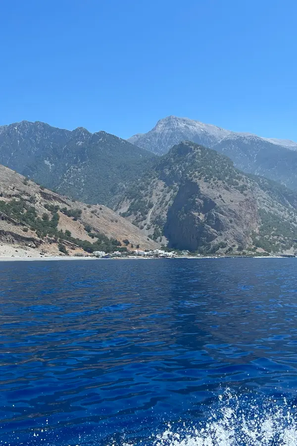 Picturesque views of Agia Roumeli village nestled at the headland overlooking the deep Aegean Sea.